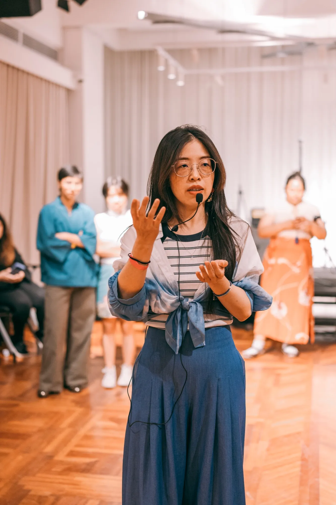 Penny explaining a concept to the class through a headset microphone